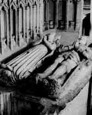 Effigies in the chancel lie under the remains of the partially destroyed chantry.